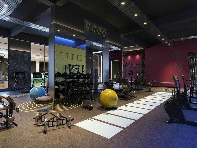 Interior of a modern premium gym with yellow lighting