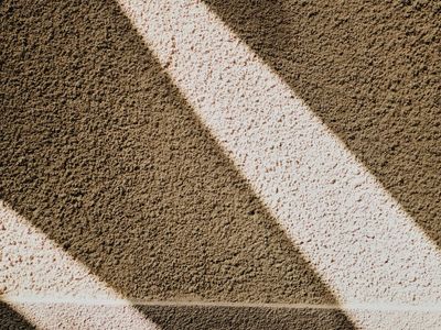 Shadow of an athlete on a textured dark wall
